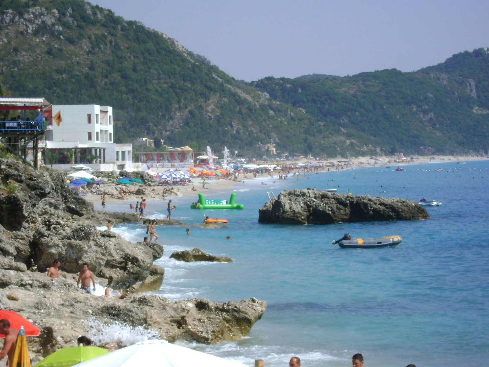Dhermi beach, Albania โ rocky shoreline with mountains and clear water