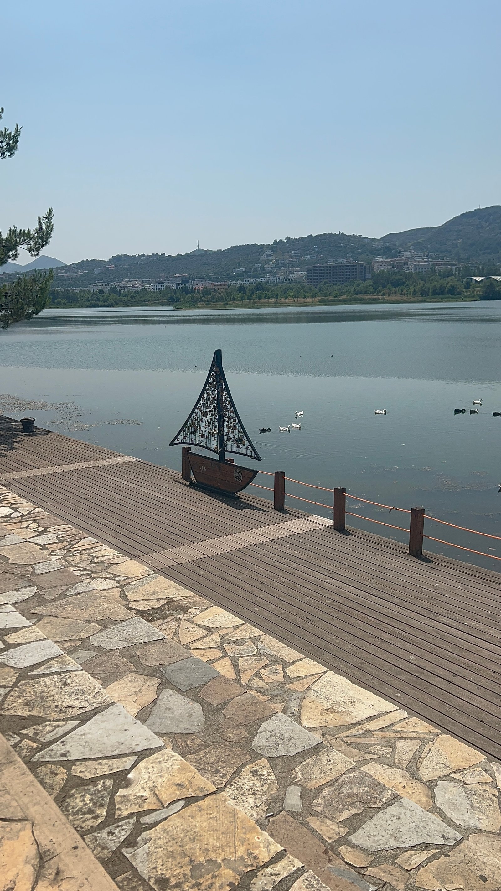Lakeside promenade in Albania — flat, paved walkway along the water