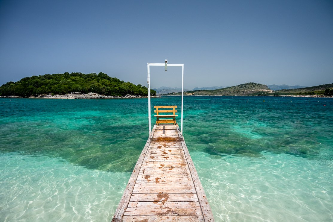 Ksamil beach, Albania โ iconic wooden pier over crystal clear turquoise water